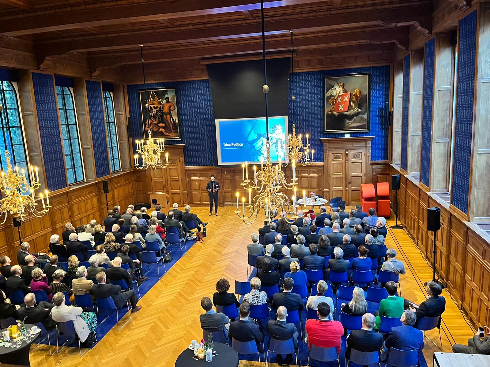 Room full of guests during a symposium for international European law firm